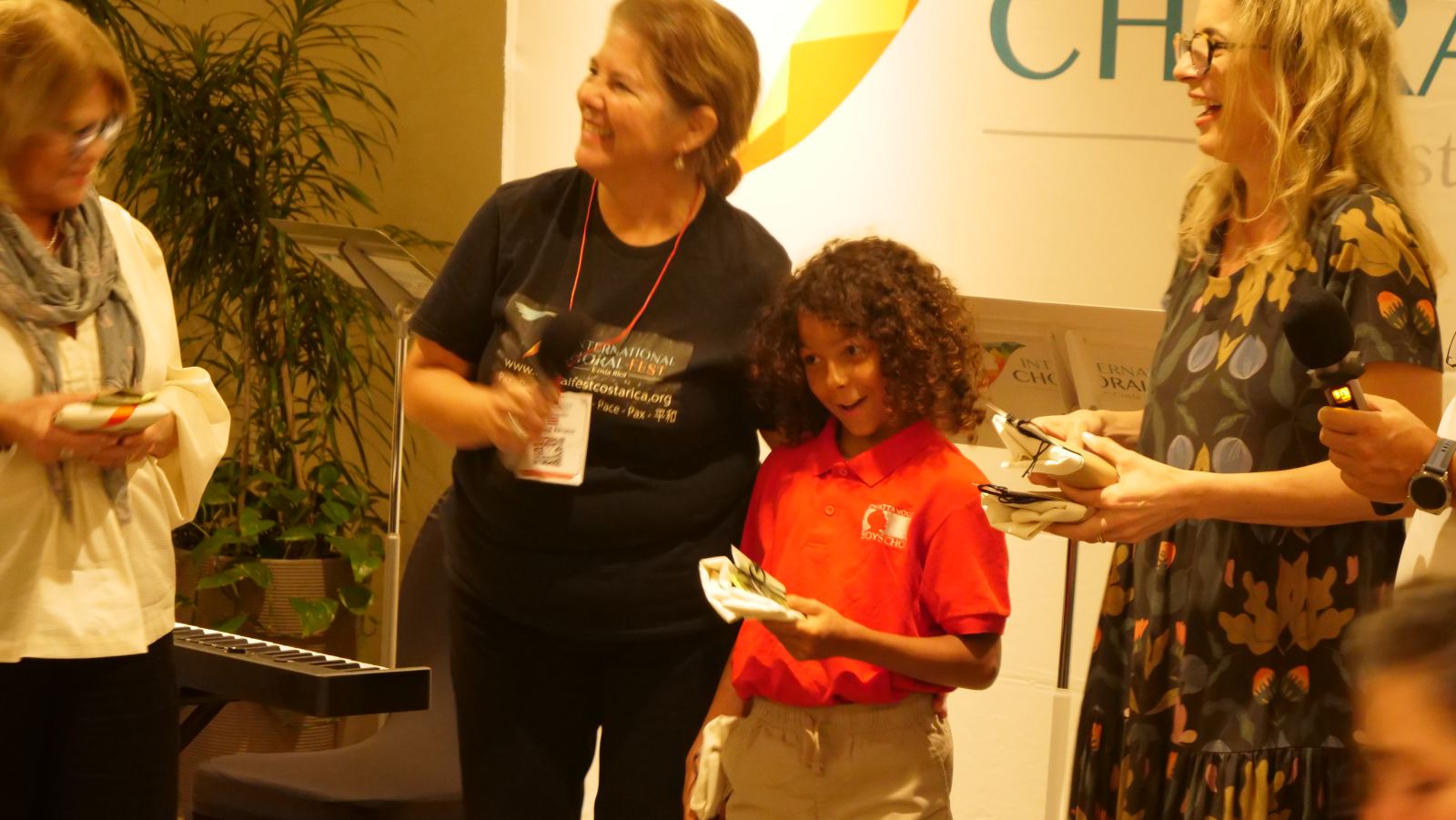 Interview in front of the International Choral Fest Costa Rica banner.